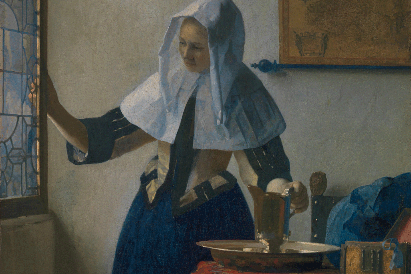 Detail view of Johannes Vermeer's "Young Woman with a Water Pitcher" showing the upper body of a woman wearing Dutch Golden Age clothing